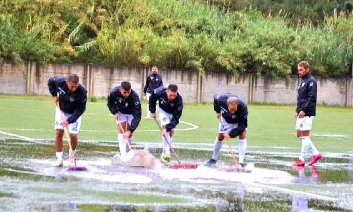 Paola, la squadra avversaria costretta ad asciugare il campo di calcio con le scope prima della gara