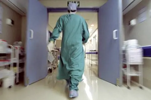 Doctor rushing in hallway , Getty Images/Pixland