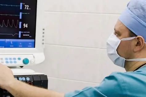 anesthesiologist with equipment in operation room