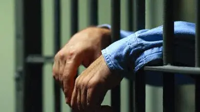 Man Behind Bars , \\u00A9 Royalty-Free/CORBIS