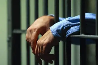 Man Behind Bars , \\u00A9 Royalty-Free/CORBIS