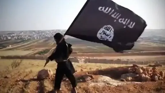 (FILES) - A file image grab taken from a video uploaded on YouTube on August 23, 2013 allegedly shows a member of Ussud Al-Anbar (Anbar Lions), a Jihadist group affiliated to the Islamic State of Iraq and the Levant (ISIL), Al-Qaeda\\'s front group in Iraq, holding up the trademark black and white Islamist flag at an undisclosed location in Iraq\\'s Anbar province. ISIL gunmen seized Iraq\\'s second-largest city on June 10, 2014 as troops threw away their uniforms and abandoned their posts, officials said, in another blow to the Iraqi authorities, who appear incapable of stopping militant advances. Arabic writing on the flag reads: \"There is not God but God and Mohammed is the prophet of God.\" AFP PHOTO / YOUTUBE == RESTRICTED TO EDITORIAL USE - MANDATORY CREDIT \"AFP PHOTO / YOUTUBE \" - NO MARKETING NO ADVERTISING CAMPAIGNS - DISTRIBUTED AS A SERVICE TO CLIENTS FROM FROM ALTERNATIVE SOURCES, THEREFORE AFP IS NOT RESPONSIBLE FOR ANY DIGITAL ALTERATIONS TO THE PICTURE\\'S EDITORIAL CONTENT, DATE AND LOCATION WHICH CANNOT BE INDEPENDENTLY VERIFIED ==== , AFP