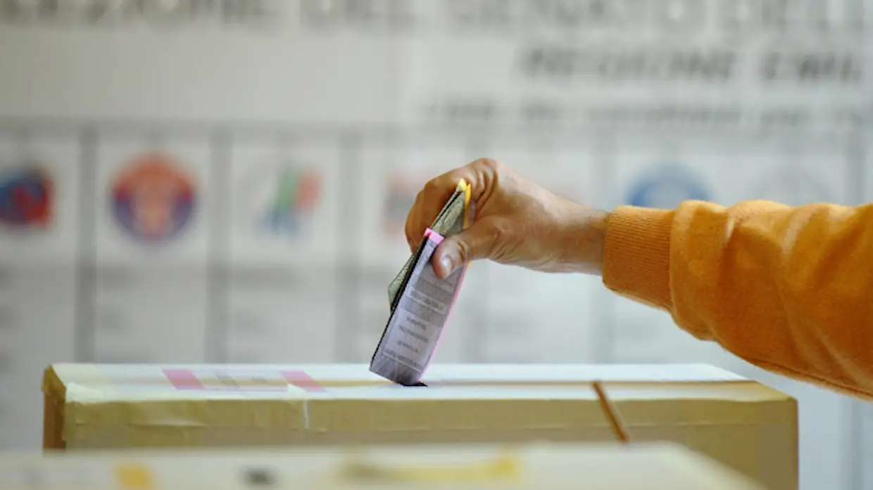 Italy\\'s voter casts their ballots at a polling station in Bologna on April 13, 2008. Italians began voting in general elections likely to usher conservative Silvio Berlusconi into the prime minister\\'s office for a third time at the expense of new centre-left flagbearer Walter Veltroni. AFP PHOTO / Vincenzo Pinto (Photo credit should read VINCENZO PINTO/AFP/Getty Images) , AFP/Getty Images