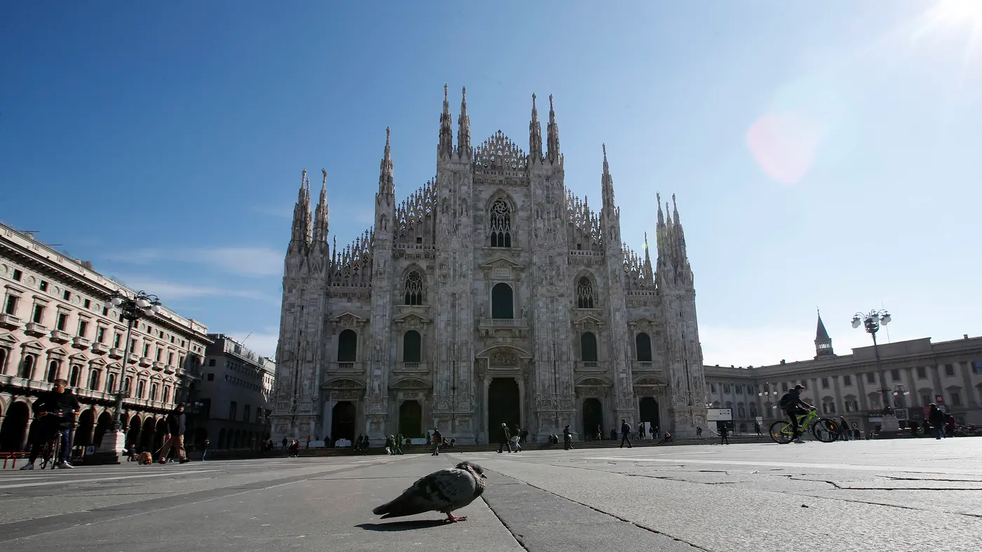 A pigeon stands in an almost empty Duomo cathedral square, in downtown Milan, Italy, Sunday, March 8, 2020. Italy announced a sweeping quarantine early Sunday for its northern regions, igniting travel chaos as it restricted the movements of a quarter of its population in a bid to halt the new coronavirus\\\\\\' relentless march across Europe. (AP Photo/Antonio Calanni) , APN