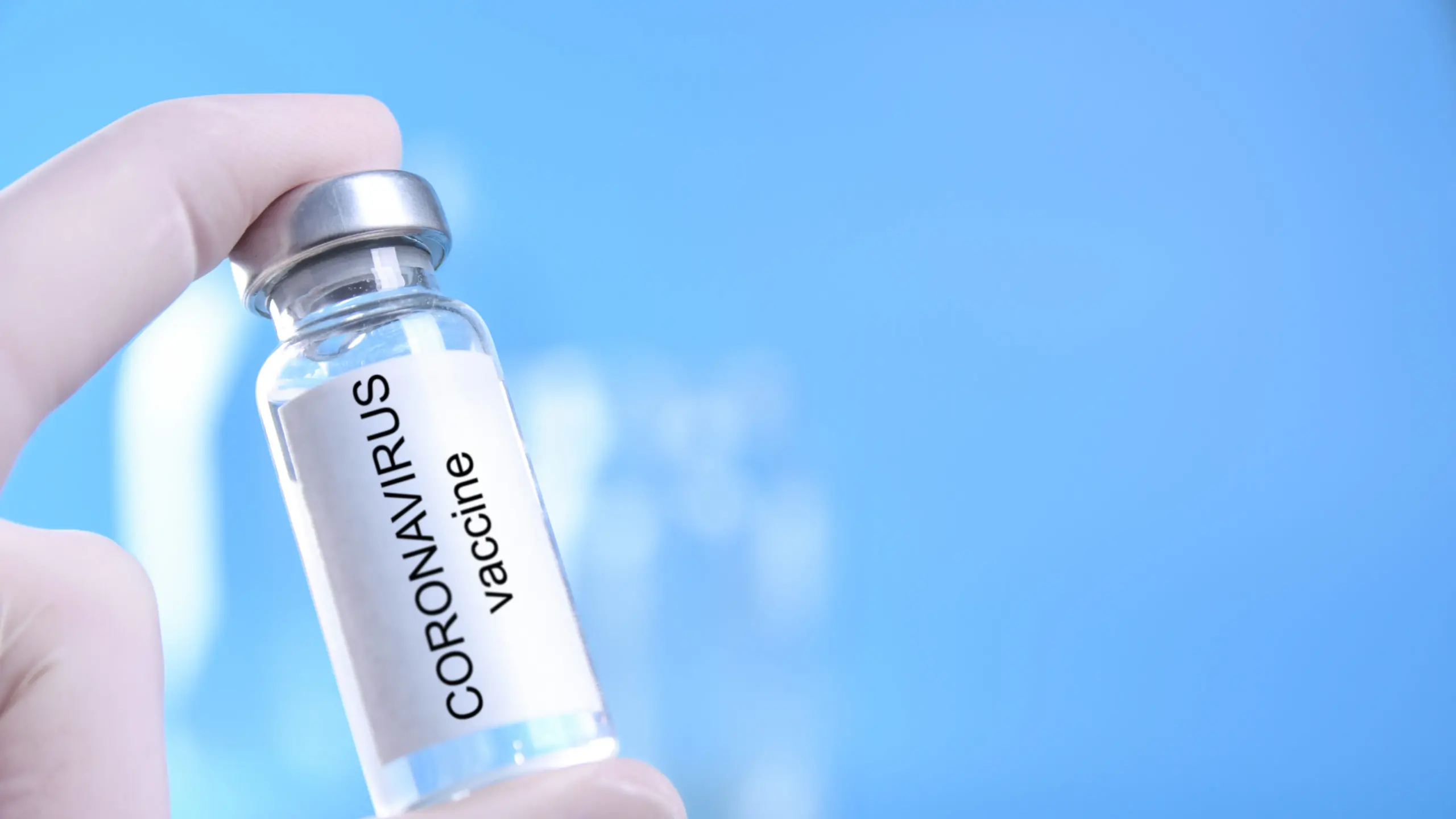 Doctor or nurse hand with nitrile glove holding coronavirus vaccine shot for baby vaccination, medicine and drug concept. , Ivan - stock.adobe.com