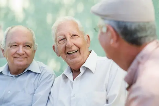 Group of happy elderly men laughing and talking