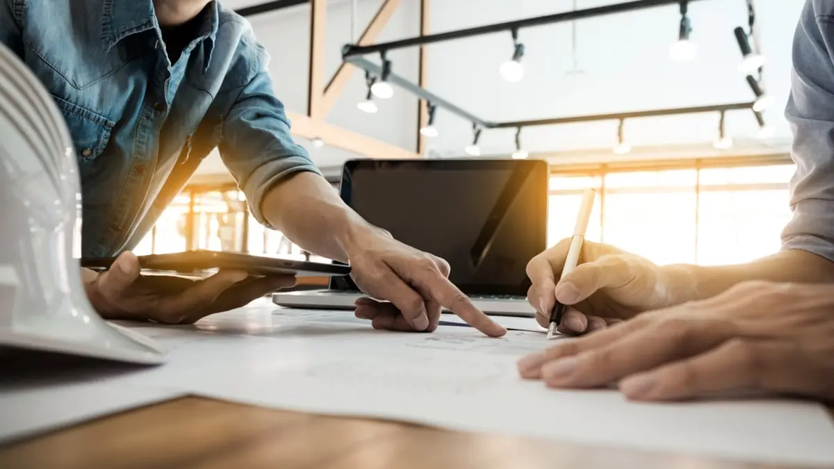 Two Architects engineer discussing data working and tablet, laptop with blueprint - Closeup on hands and project print. , Getty Images/iStockphoto