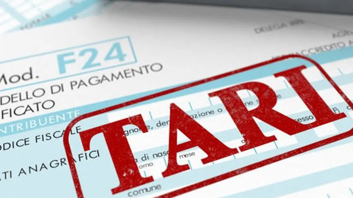 close up view of F24 form for italian taxes,the word tari and an electronic calculator (3d render) , Getty Images/iStockphoto