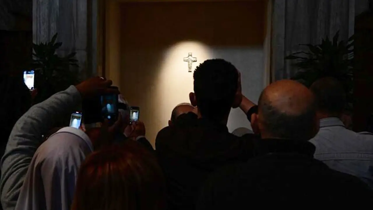People stand in front of the tomb of Pope Francis on the first day of its opening to the public in Santa Maria Maggiore in Rome on April 27, 2025. (Photo by Tiziana FABI / AFP) , AFP