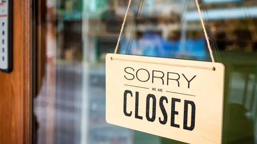 Sorry we are closed sign board hanging on a door of cafe , Getty Images/iStockphoto