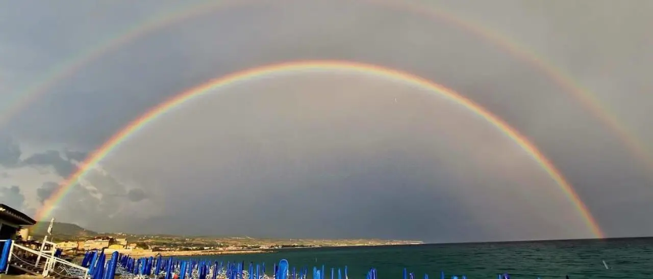 Lo spettacolo del doppio arcobaleno sulla spiaggia di Vibo Marina: magia della natura dopo la pioggia agostana
