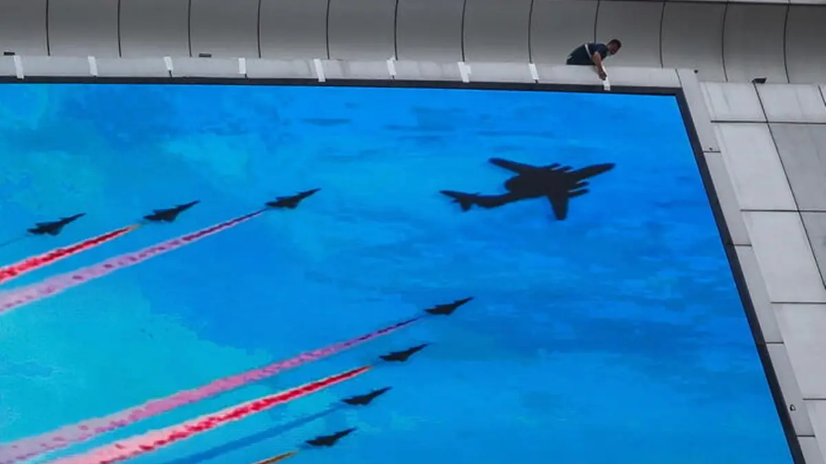 epa10101505 A man puts a tape along an advertisement to mark the 95th founding anniversary of the People\\'s Liberation Army (PLA in Beijing, China, 01 August, 2022. China has raised a warning stating its military will not sit idle if US House of Representatives Speaker Nancy Pelosi visits Taiwan. Pelosi is leading a Congressional delegation to the Indo-Pacific region with a visit to Singapore, Malaysia, South Korea and Japan. EPA/MARK R. CRISTINO , EPA