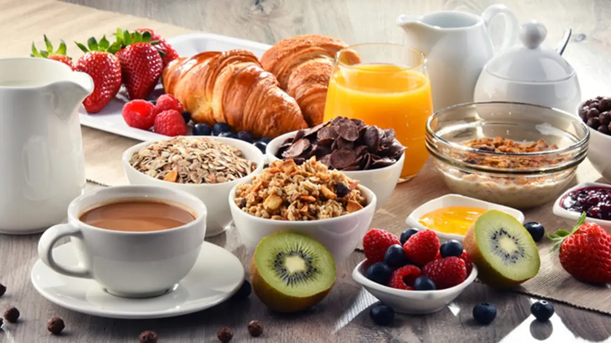Breakfast served with coffee, orange juice, croissants, cereals and fruits. Balanced diet. , Getty Images/iStockphoto