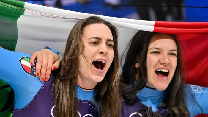 Italy\\'s Andrea Voetter (L) and Italy\\'s Marion Oberhofer (R) celebrate after crossing the finish line to win the luge women\\'s doubles run 2 at Cortina Sliding Centre during the Milano Cortina 2026 Winter Olympic Games in Cortina d\\'Ampezzo on February 11, 2026. (Photo by Tiziana FABI / AFP) , AFP
