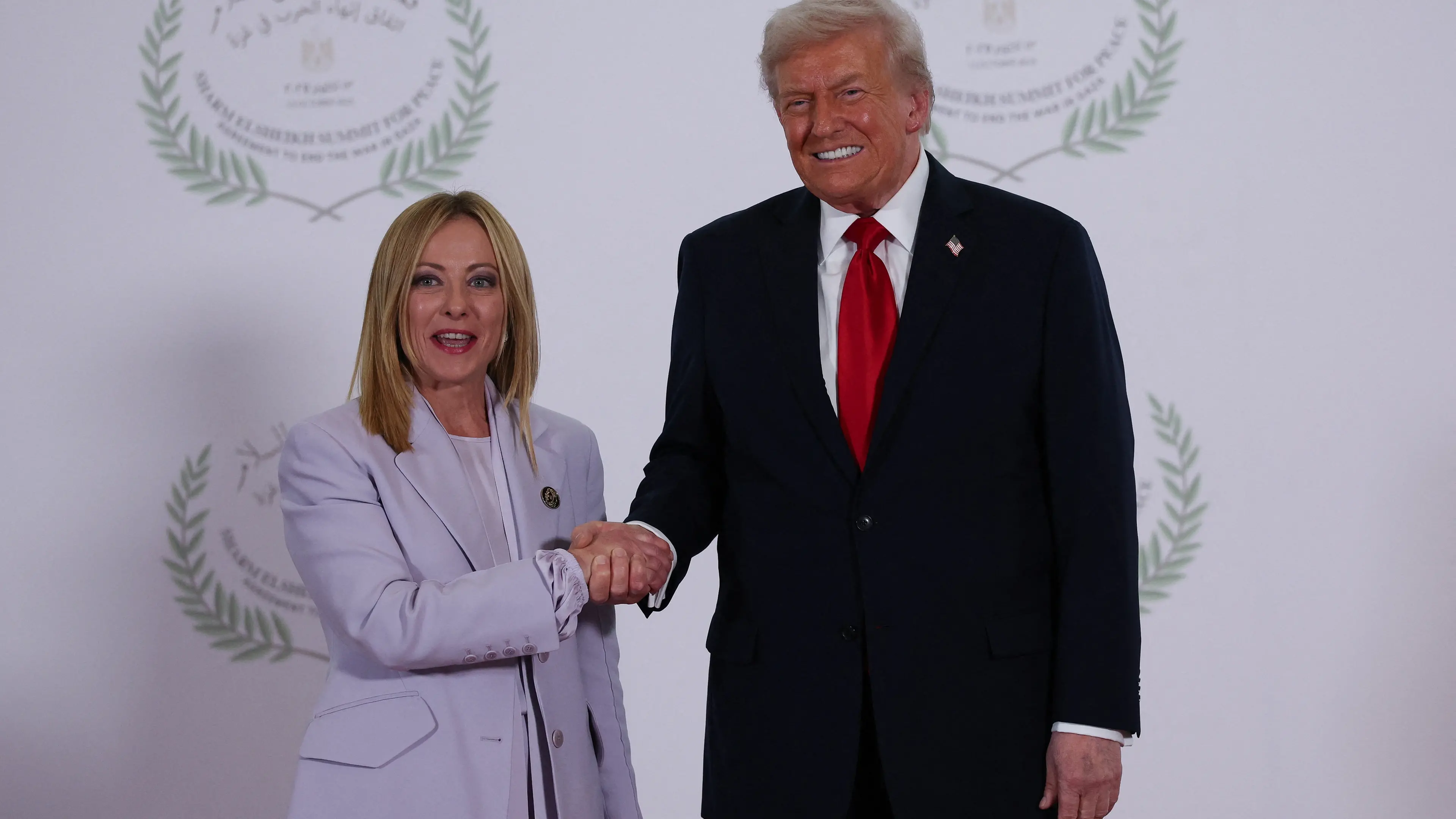 US President Donald Trump and Italian Prime Minister Giorgia Meloni shake hands as they pose for a photo at the Sharm El Sheikh Peace Summit in Egypt. Picture date: Monday October 13, 2025. , PA
