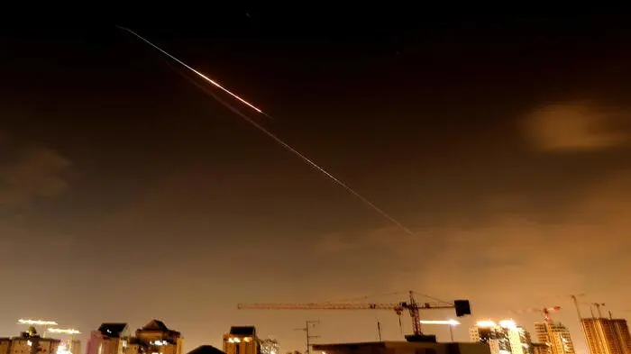 Rocket trails are seen in the sky above the Israeli coastal city of Netanya amid a fresh barrage of Iranian missile attacks late on March 27, 2026. Emergency responders said a man was killed in Israel on March 28 after the Israeli military reported missiles fired from Iran. (Photo by JACK GUEZ / AFP) / , AFP