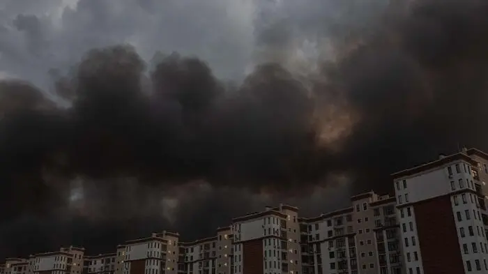 This photograph shows smoke rising over residential buildings following massive Russian ballistic missile and drone strikes on the outskirts of Kyiv early on August 5, 2026, amid the Russian invasion of Ukraine. Russian strikes on Ukraine\\'s capital and surrounding region killed at least two people and wounded dozens more, authorities said on August 5, 2026, after fresh overnight missile and drone attacks. (Photo by Roman PILIPEY / AFP) , AFP