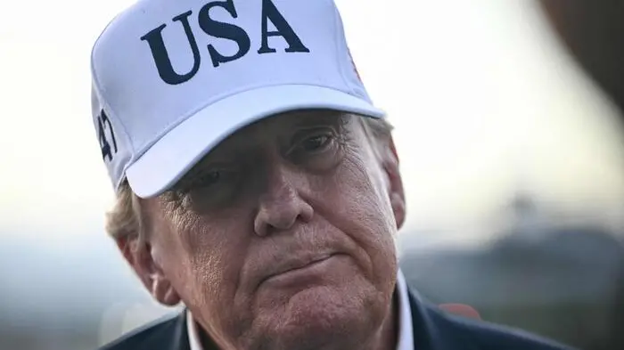 US President Donald Trump speaks to members of the media before boarding Air Force One to leave from Shannon Airport, western Ireland on September 13, 2026, after attending the final day of the Irish Open golf tournament in nearby Doonbeg. (Photo by Brendan SMIALOWSKI / AFP) , AFP